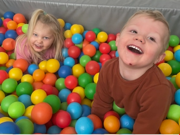 Två barn leker i bollhavet.